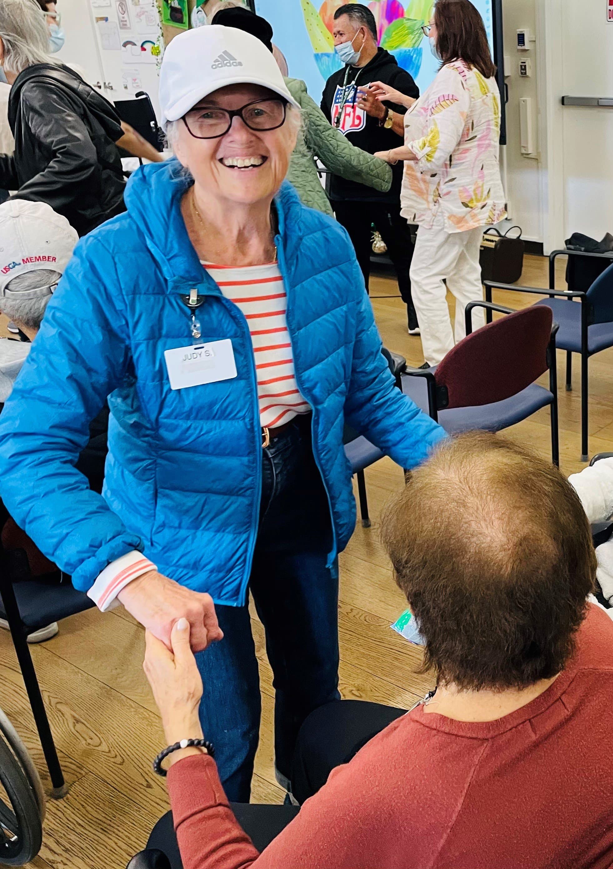 Smiling woman giving a piggyback ride to a laughing young girl.